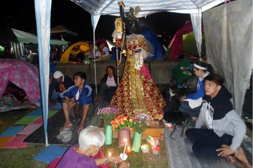 Devotees camp out with their own statue of the Black Nazarene at the overnight vigil preceding the procession. January 8, 2015. Photo by Arnulfo Fortunado.