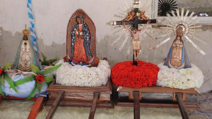 In the desert village of Osma, pilgrims making their way to the Feast of the Señor y Virgen del Milagro display the images that they carry with them all the way on andas, or carrying platforms.