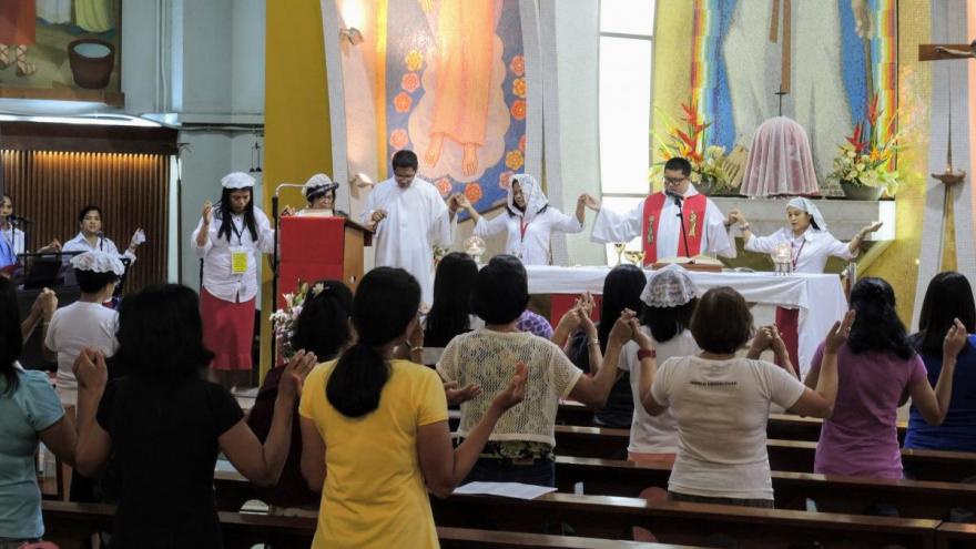 El Shaddai members at daily liturgy, St. Joseph Church, Hong Kong. Red skirts are worn by members of the Tuesday El Shaddai group.