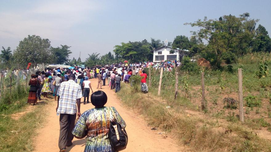 Pilgrims walk up to the outdoor compound of Mount Sion Prayer Center for its opening exorcism and healing service.
