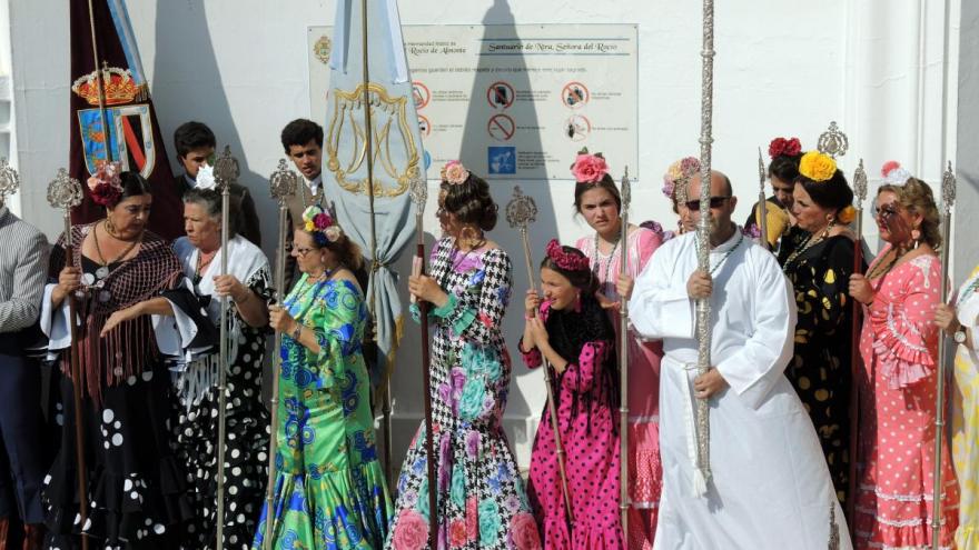 Leaders of the Hermandad Matriz line up at the front door of the sanctuary at El Rocio, Spain to receive the brotherhoods that officially participate in the annual pilgrimage feast.