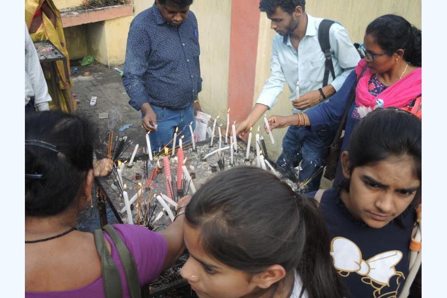 Devotees light candles to mark specific prayers or petitions.