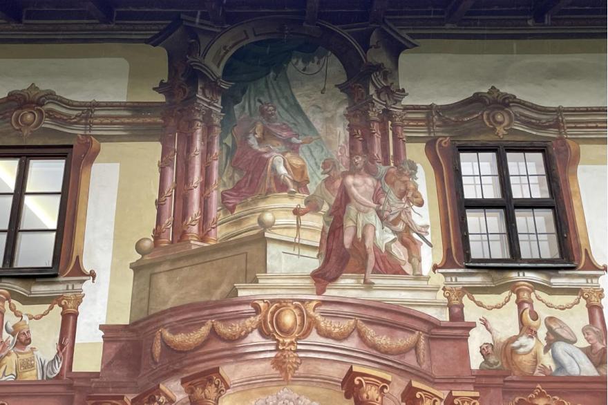 The Pilatushaus, one of the most sumptuous versions of Lüftlmalerei, or exterior stucco painting culture in town, features Pilate's judgment of Jesus  as it might have appeared in an earlier, more baroque rendition of the Play.