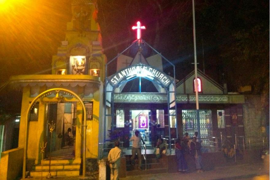 St. Anthony's Church Bengaluru is one of many privately built, unofficial shrines in a heavily trafficked slum area. To its immediate left is a similar Hindu temple.