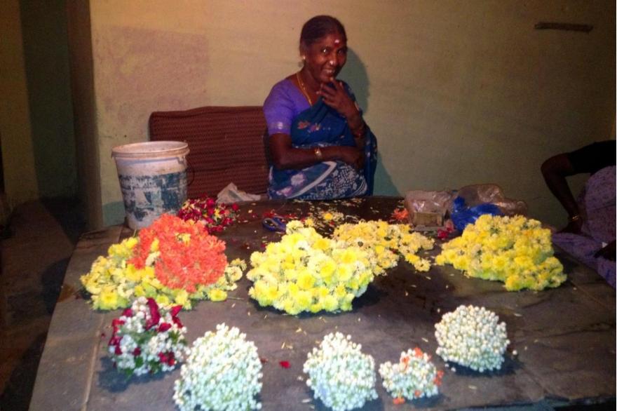 Flower vendor for offerings sits across from the Annai Vailankanni chapel.