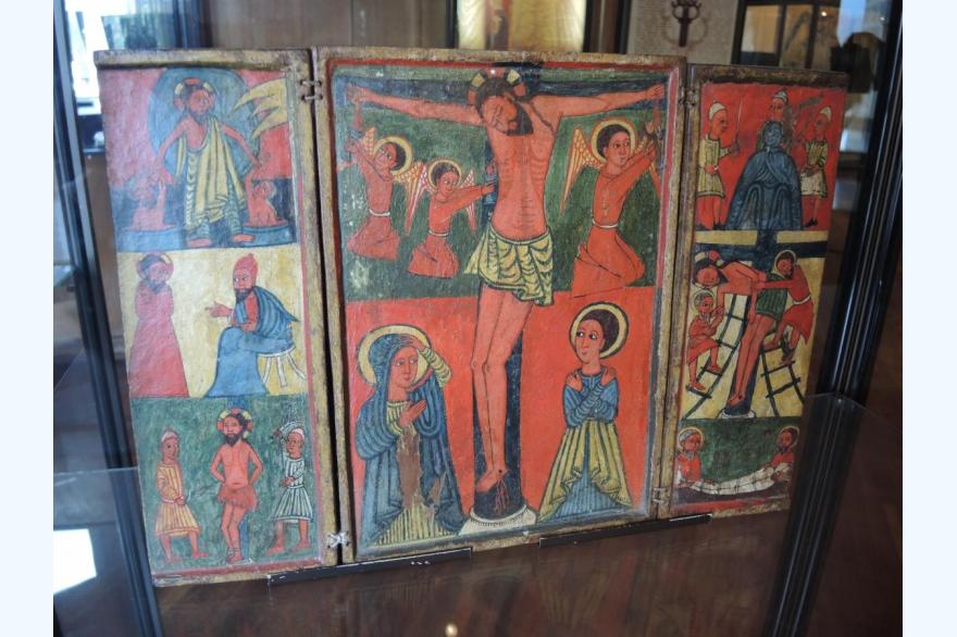 A triptych of the crucifixion in traditional Ethiopian Orthodox iconographic style.