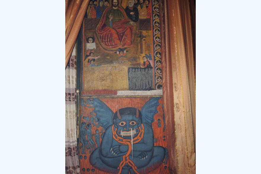 A devil at St. Raguel Orthodox church: Unlike other evil personages in Ethiopian iconography, the devil shows both eyes, but his evil status is clear.