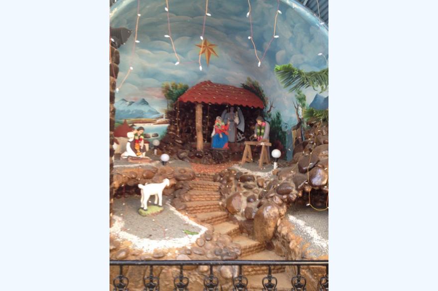 A creche at St. Mary's Forane church could be anywhere in the west, other than the colorful garlands around the figures' necks.