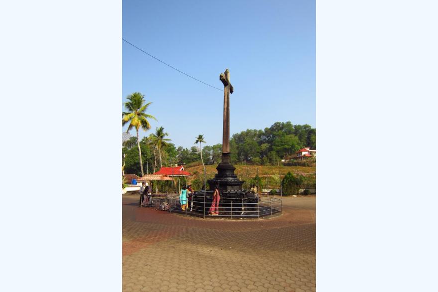 Worshipers come to add oil to the lamps ad they pray, while circumnavigating the cross in front of St. Mary's Forane Syro-Malabar church.