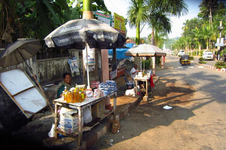 Street vendors sell oil and candles to bring to the oil lamp at St. Mary's Forane church, Kuravilangad, Kerala.