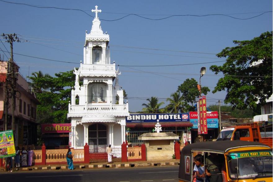 A freestanding shrine in the center of Kuravilangad is a spot where passersby will regularly stop to offer a prayer. Large and small shrines of this type are common in Christian areas of Kerala.