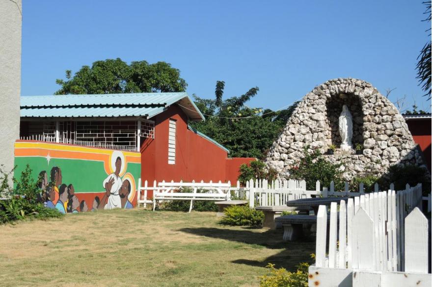 Two images at St. Anne's Church, West Kingston, Jamaica, signal different aspects and eras of Jamaican Catholicism.