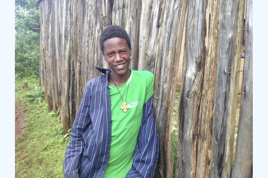 A young man in the Gurage region of Ethiopia. Simple wooden crosses of designs like this are fairly typical to wear.