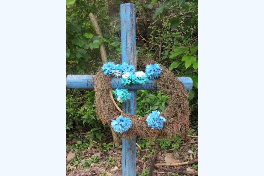 A roadside memorial near La Paz, El Salvador. Thousands of similar memorials, often well-tended, dot the roads in the country. Photo by Marty Kelly.