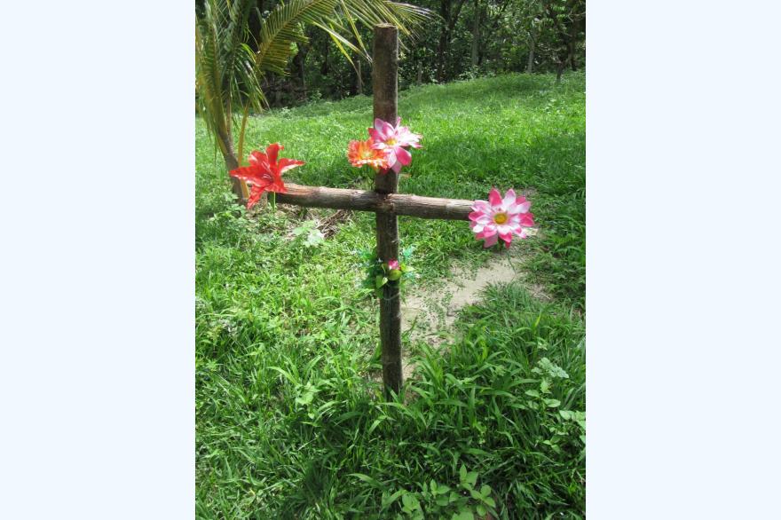 A roadside memorial near La Paz, El Salvador. Thousands of similar memorials, often well-tended, dot the roads in the country. Photo by Marty Kelly.