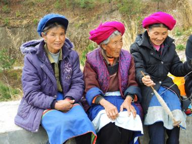Women waiting outside Niuren church for the start of Easter services. Yunnan Province, 2015.