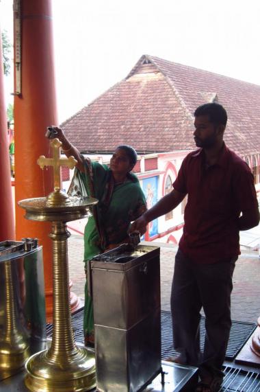 Pouring oil over a cross, a popular form of devotion in Syro-Malabar churches. St. Mary's Forane, Kuravilangad.
