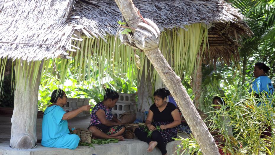 Women weave nuunuw in the p'eebaay, or community meeting house before Easter Sunday Mass, Holy Trinity sub-parish, Yap.