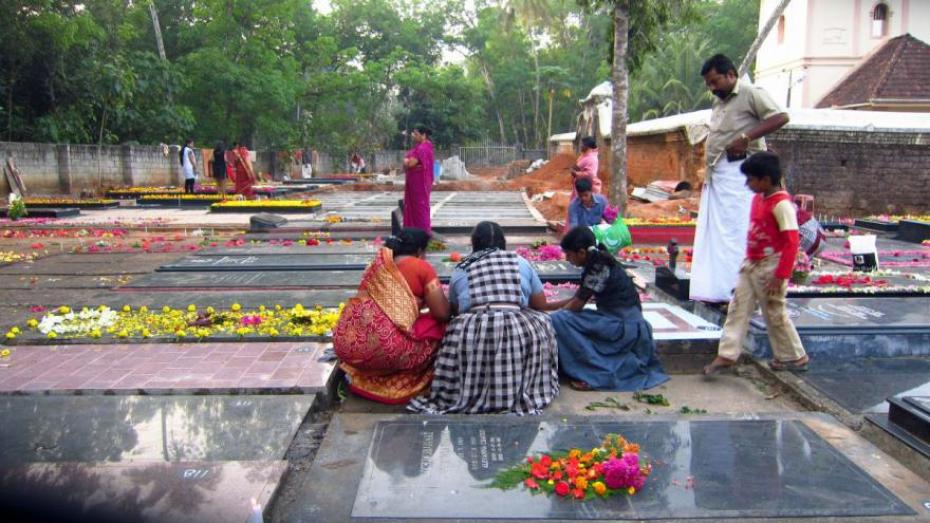 Women decorate tombstones before the Day of the Dead procession in India.