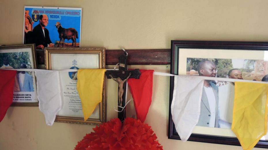 Religious and familial decorations in a family home near Jinja Karoli, Uganda.