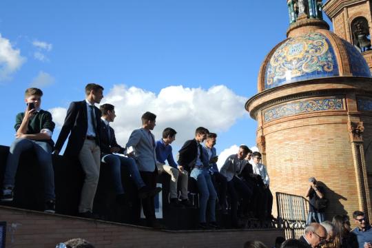 Young men dressed up in their Palm Sunday best line the bridge waiting for the procession of La Estrella.