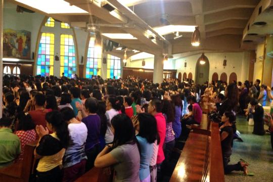 Filipina parishioners fill the nine masses offered each Sunday at St. Joseph's Church, both downstairs and in the balcony above.